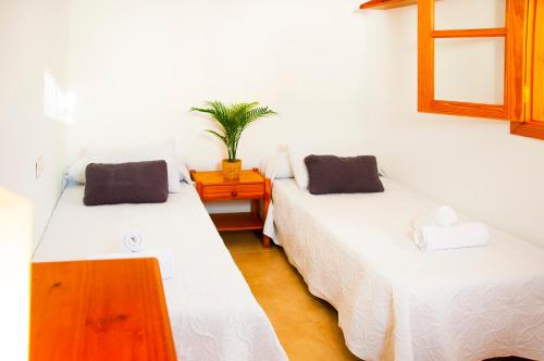 a room with two beds and a wooden table at La Concha Beach apartament in Arrecife