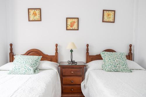 two beds sitting next to each other in a bedroom at Apartment Nieves 2 in Nerja