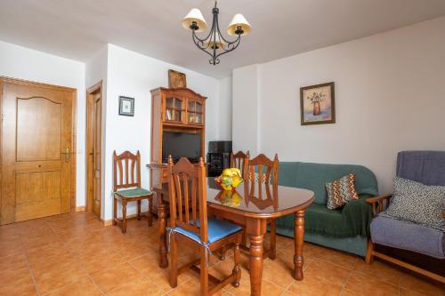 a living room with a table and a green couch at Apartment Nieves 2 in Nerja