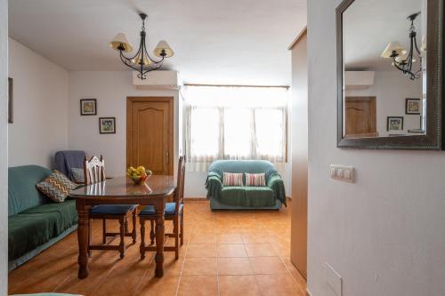 a living room with a table and a green couch at Apartment Nieves 2 in Nerja