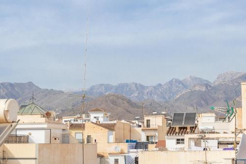 a group of buildings with mountains in the background at Apartment Nieves 2 in Nerja
