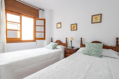 a bedroom with two beds and a window at Apartment Nieves 2 in Nerja