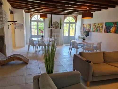 a living room with a couch and a table at Gîte de la Mignonerie du Château de Jallanges pour 19 personnes avec 4 ou 7 chambres in Vernou-sur-Brenne