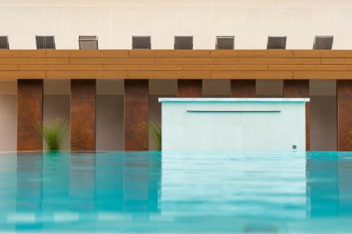 a pool of water in front of a building at Hotel Universal Terme in Abano Terme