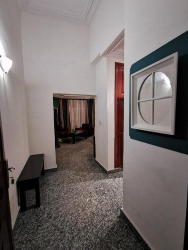 a room with a hallway with a window on the wall at L'Address in Cotonou