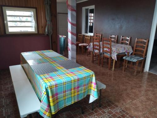 a room with a table and chairs and a table and a table and chairsktop at case ti kaf in Saint-Leu
