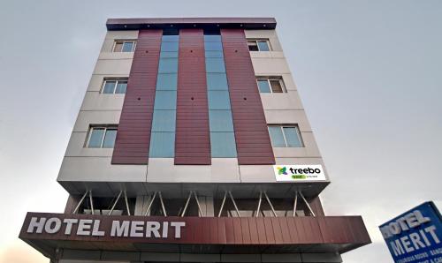 a hotel sign in front of a building at Treebo Trend Merit in Indore