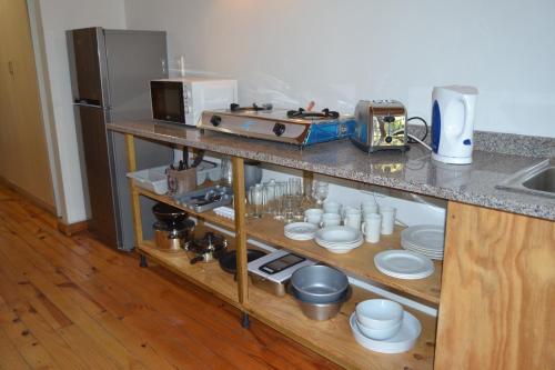 a kitchen with a counter with dishes and a microwave at The Farmers Lodge in Thorndale