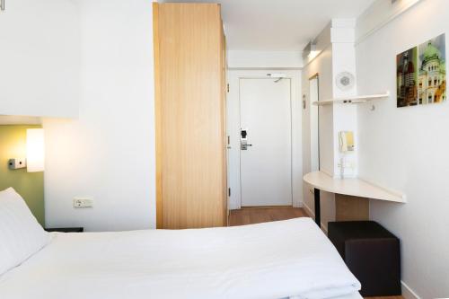 a small room with a bed and a table at Good Morning+ Göteborg City in Gothenburg