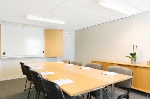 a conference room with a large table and chairs at Good Morning+ Göteborg City in Gothenburg