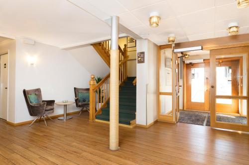 a hallway with a staircase in a house at Good Morning+ Göteborg City in Gothenburg