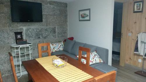 een woonkamer met een bank en een tafel bij Casa d'Alicinha - Férias no Douro in Baião
