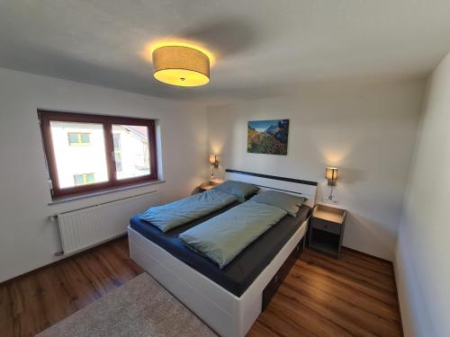 a bedroom with a bed and a window at Ferienwohnung Scharf in Reutte