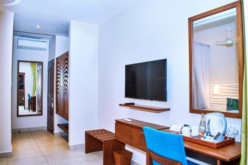 A television and/or entertainment center at Neptune Village Beach Resort & Spa - All Inclusive