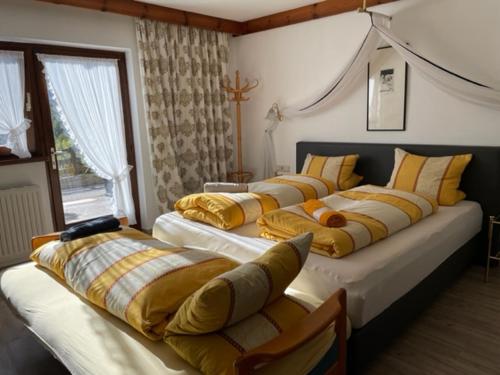 a bedroom with four beds with pillows on them at Landhaus Töchterle in Telfes im Stubai