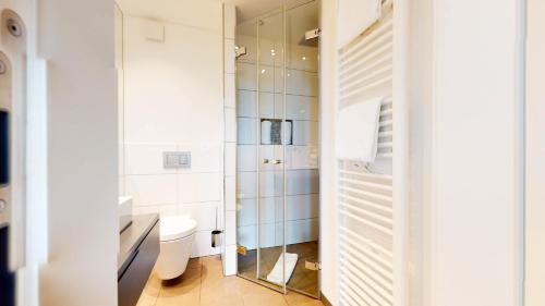 a bathroom with a toilet and a glass shower at Ankerhaus Ankerhaus 4 in Hörnum