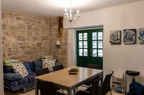 a living room with a table and a couch at House Beatrix in Stari Grad