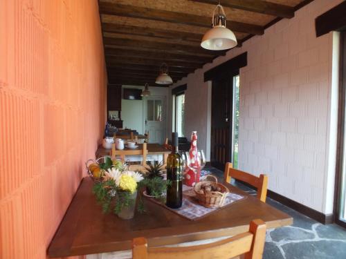 a dining room table with wine bottles and flowers on it at Apartamentos Puerta del Castro in Coaña