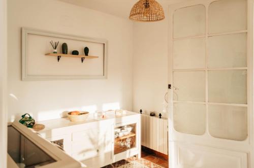 a bathroom with a white cabinet and a white door at El Riu del Cel in Lloret de Mar