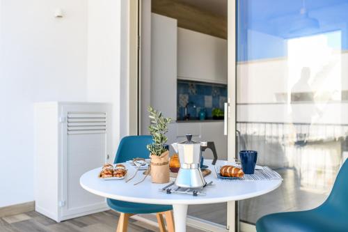 a table with a coffee maker on top of it at Mare Villas Pescoluse- Design Apartment in Marina di Pescoluse