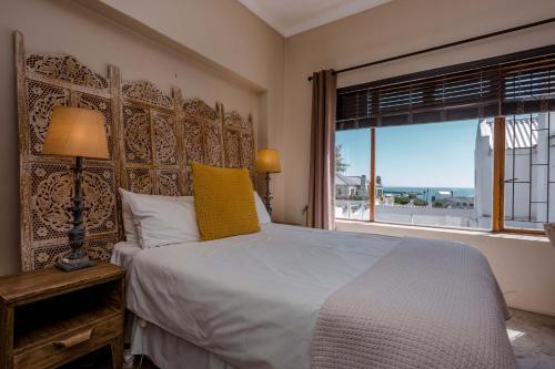 a bedroom with a large bed and a window at Saxon Lodge in Gansbaai