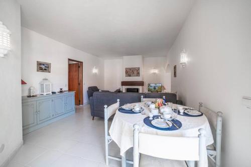 a dining room and living room with a table and chairs at Spacious Two bedroom apt, 200m from the beach in Carvoeiro