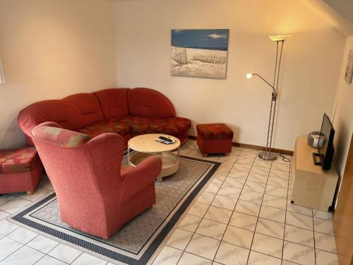 a living room with a couch and a table at Schwalbennest - Fewo 1 in Nordstrand