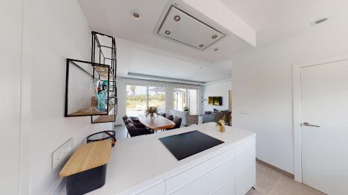 a living room with white walls and a white counter at Apartamentos y Villas Oliva Nova Golf Resort in Oliva