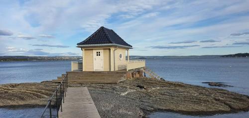 a small building on a island in the water at Spacious Fornebu apartment near the sea in Fornebu