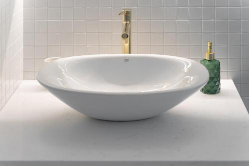 a white bath tub sitting on a counter in a bathroom at Hanza Tower 22 WHITE Jacussi & Sauna & Pool & SPA in Szczecin