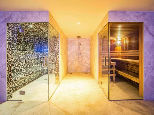 a bathroom with a shower and a glass shower stall at Mercure Riga Centre in Rīga