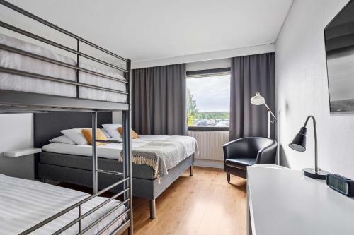 a hotel room with a bunk bed and a chair at Best Western Hotell SoderH in Söderhamn