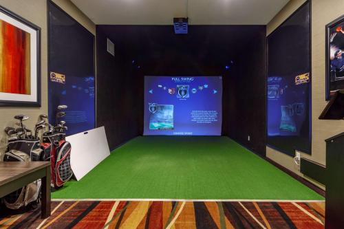 a room with a green floor and a screen at Best Western Plus Drayton Valley in Drayton Valley