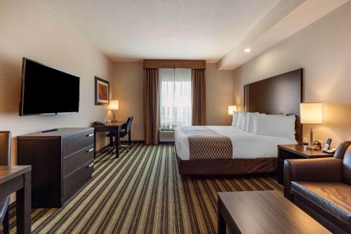 a hotel room with a bed and a desk at Best Western Plus Drayton Valley in Drayton Valley