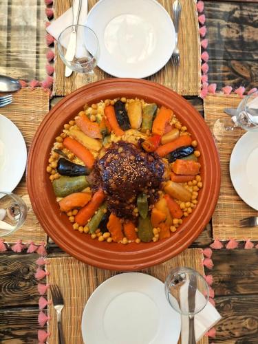 a plate of food with vegetables on a table at Villa Serena Marrakech - Maison d'hôtes in Marrakech
