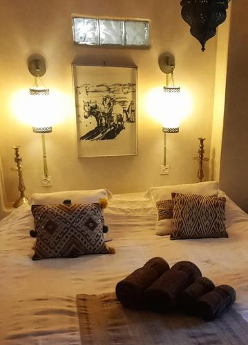 a bedroom with a large bed with two lamps at Maison d'Hôtes Irocha in Tisselday