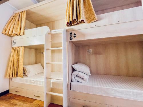 a bunk bed with two beds in a room at Evergreen Hostel in Almaty
