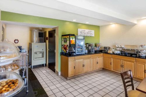 a large kitchen with wooden cabinets and a counter at Sleep Inn Gaffney at I-85 in Gaffney
