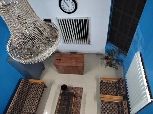 an overhead view of a room with a clock and chandelier at Gruham Malpe Beach Homestay Udupi in Malpe