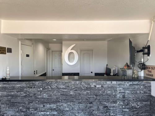 a lobby with a large white sign on the wall at Motel 6 Henderson NV in Las Vegas