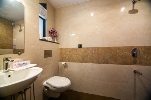 a bathroom with a toilet and a sink at Regenta Inn Palacio De Goa, Panjim in Panaji