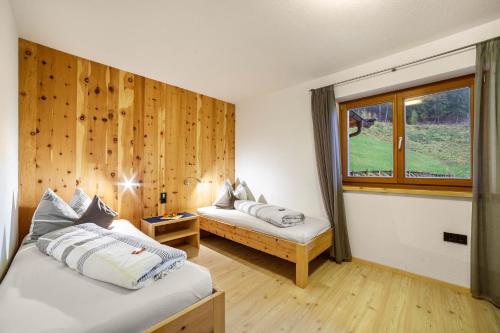 Zimmer mit 2 Betten und einem Fenster in der Unterkunft Residence Kalchgruberhof Bergzirbe in Ulten