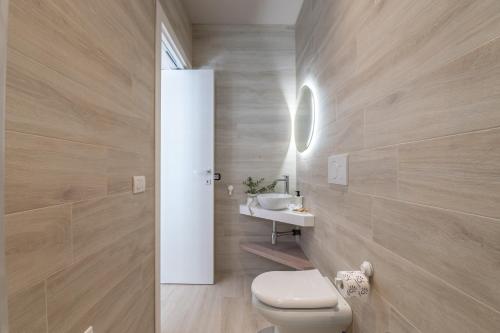 a bathroom with a toilet and a sink at Mare Villas Pescoluse- Design Apartment in Marina di Pescoluse
