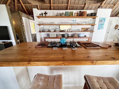 a kitchen with a wooden counter top in a room at Mar-Me-Quer, Eco Beach Retreat in Inhambane