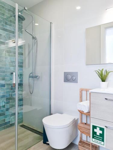a bathroom with a shower with a toilet and a sink at CASINHA DE FERRAGUDO - Terraço Privado, AC, WiFi, Centro 250m in Ferragudo
