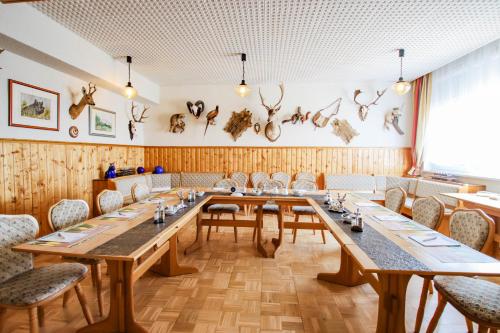 a large room with a long table and chairs at Panorama Ferien Hotel Harz in Güntersberge