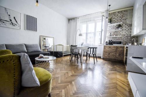 a living room with a couch and a table at LION apartments - Gold in Krakow