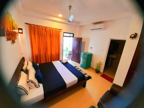 a bedroom with a large bed and a window at Weligama Watergate in Weligama