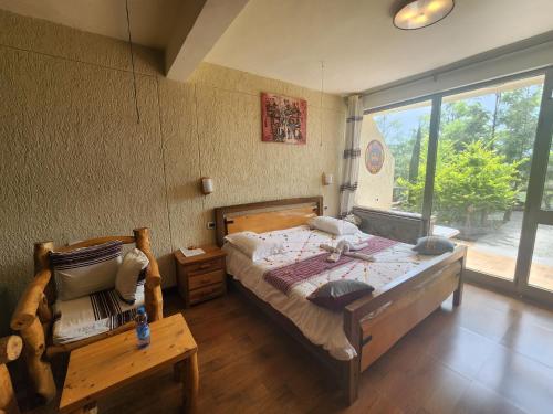 a bedroom with a bed and a large window at Sora Lodge Lalibela in Lalībela