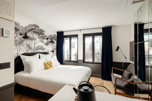 Ένα ή περισσότερα κρεβάτια σε δωμάτιο στο My Maison In Paris Invalides